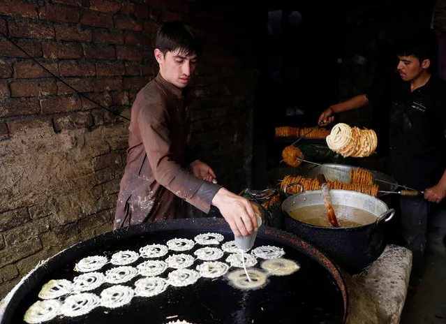 Afghan men make sweets at a small traditional factory ahead of the Eid al-Adha in Kabul, Afghanistan August 19, 2018. (Photo by Mohammad Ismail/Reuters)
