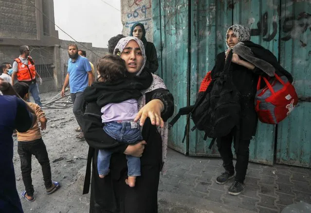 Palestinian women flee following an Israeli strike vollowing an Israeli strike in the southern Gaza Strip, as Deadly Israeli Strikes continue for the sixth consecutive day on Thursdy, October 12, 2023. (Photo by Ismael Mohamad/UPI/Alamy Live News)