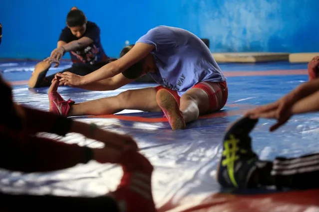 Iraqi women exercise during practice at the sports club in Diwaniya, Iraq on November 10, 2018. The first ended when the club in Diwaniya was disbanded in 2012 after complaints from the local community that the sport was in defiance of local traditions and culture. (Photo by Alaa Al-Marjani/Reuters)