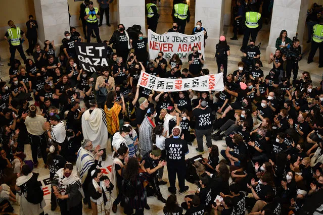 Hundreds of pro Palestine liberation activists, many of them Jews, perform a sit in inside the Cannon House Office building on Capitol Hill l in Washington, D.C., October 18, 2023, to demand peace and the end of the siege of the Gaza Strip. (Photo by Astrid Riecken For The Washington Post)