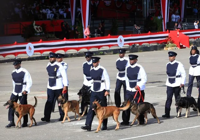 Members of the canine department of the Trinidad and Tobago Police participate in the traditional military parade, which this year commemorates the 60th anniversary of the independence of the republic, held in Queen's Park Savannah in the capital Port of Spain 31 August 2022. Trinidad and Tobago celebrated its 60th anniversary of independence from the United Kingdom on 31 August with the return of the traditional military parade, after two years suspended due to the pandemic, and with clear signs of the prevailing political division. (Photo by Andrea De Silva/EPA/EFE)