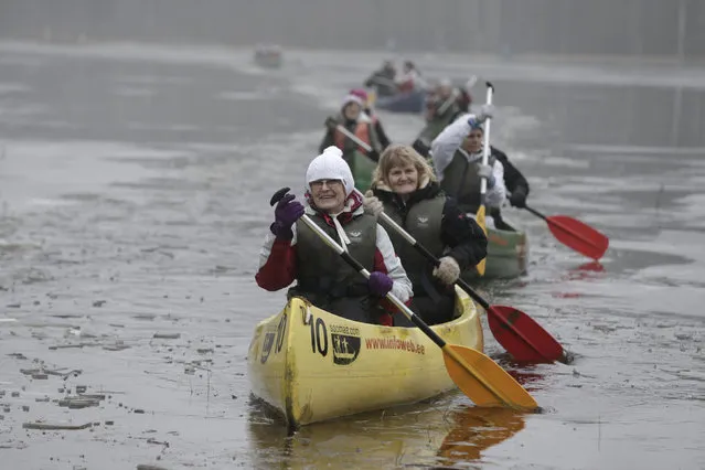 People canoe on a flooded meadow in Soomaa national park, Estonia, February 7, 2016. In this Estonian region hit by floods every spring the natural disaster is used to attract visitors and organise canoe tours through flooded territories. The floods are called Fifth Season by local people. (Photo by Ints Kalnins/Reuters)