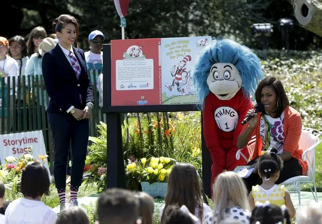 U.S. first lady Michelle Obama (R) reads “Oh, the Things You Can Do That Are Good For You”, a Tish Rabe adaptation of a Dr. Seuss book, to children visiting the White House during the annual Easter Egg Roll in Washington April 6, 2015. At left is Genevieve Goings from the Disney Channel. (Photo by Gary Cameron/Reuters)