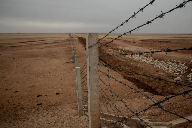 A barbed wire fence mark the limits of the Zurihe military training camp. Local herders have been expropriated without proper compensation for the creation of the base. (Photo by Gilles Sabrie/The Washington Post)