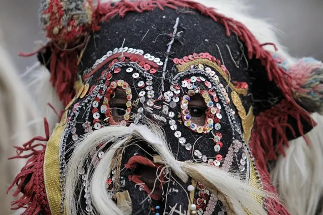 A masked dancer from the Macedonian town of Prilep takes part in the 28th International Festival of Masquerade Games “Surva” in the town of Pernik, Bulgaria Saturday, Januaru 26, 2019. (Photo by Valentina Petrova/AP Photo)