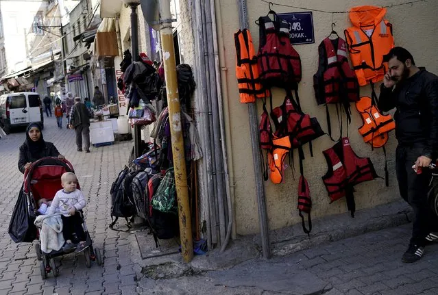 Life jackets are displayed for sale at a clothing shop on a main street in the Aegean port city of Izmir, western Turkey, March 7, 2016. Many migrants pass through Izmir before attempting to cross the sea into Greece. (Photo by Umit Bektas/Reuters)