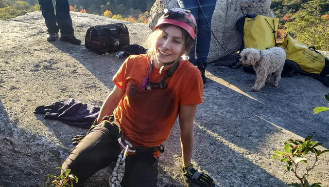 Jessica Van Ord, a park official, leaves a fissure after she rescued a 12-year-old dog found trapped after five days deep inside the narrow rocky crevice at Minnewaska state park preserve in Kerhonkson, New York on October 12, 2021. (Photo by AP Photo/Stringer)