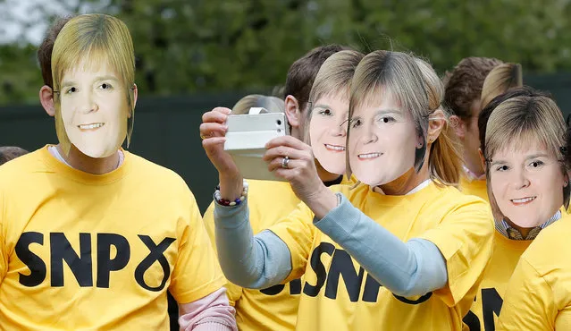 Conservative Party activists pose for a selfie whilst wearing face masks of Scottish National party leader Nicola Sturgeon during a stunt outside the Houses of Parliament, in central London, Britain, May 1, 2015. (Photo by Peter Nicholls/Reuters)