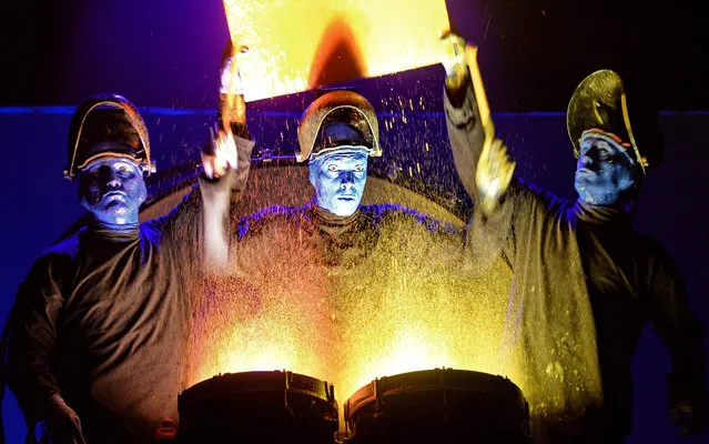 The Blue Man Group performs on stage during a media preview ahead of their show in Singapore on March 31, 2016. Blue Man Group was started by three friends in New York in 1991 as a way to celebrate the human spirit through music, science, art and theater. (Photo by Roslan Rahman/AFP Photo)