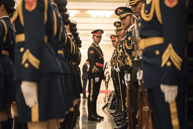 An officer checks the positions of Chinese paramilitary guards before the welcome ceremony of French Prime Minister Bernard Cazeneuve at the Great Hall of the People in Beijing on February 21, 2017. Cazeneuve is on a three-day visit to China until February 23. (Photo by Fred Dufour/AFP Photo)
