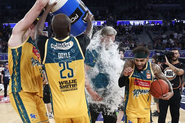 Milton Doyle and Will Magnay of the JackJumpers pour a powerade bucket over JackJumpers head coach Scott Roth after winning game five of the NBL Championship Grand Final Series between Melbourne United and Tasmania JackJumpers at John Cain Arena, on March 31, 2024, in Melbourne, Australia. (Photo by Daniel Pockett/Getty Images)