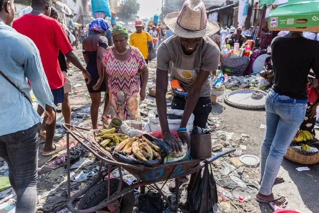 A merchant standing with a handcart of food products to sell in the petion-ville market in the street amid the ongoing insecurity and political instability in Port-au-Prince, Haiti, March 21, 2024. (Photo by Guerinault Louis/Anadolu via Getty Images)