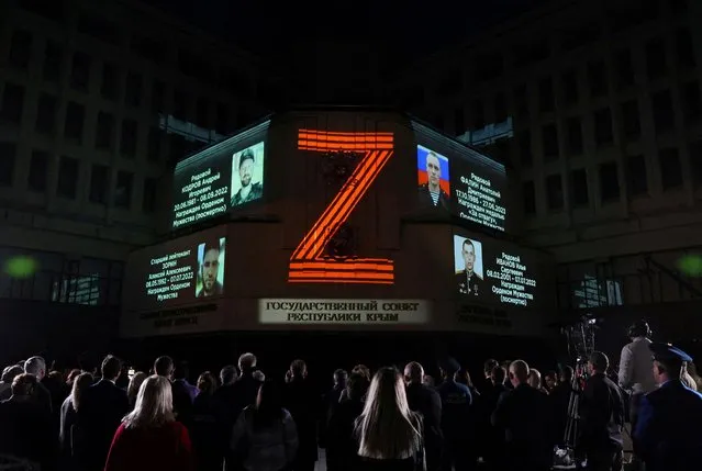 Portraits of Russian service members killed in Russia-Ukraine conflict and the symbol “Z” are projected onto the State Council building in Simferopol, Crimea on April 8, 2024. (Photo by Alexey Pavlishak/Reuters)
