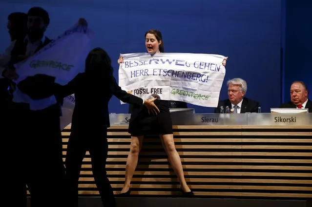 An environment activist displays a banner that reads, “Better to go away Mr. Etschenberg! Fossil Free – Greenpeace” during the annual shareholders meeting of German power supplier RWE in Essen, Germany April 20, 2016. (Photo by Wolfgang Rattay/Reuters)