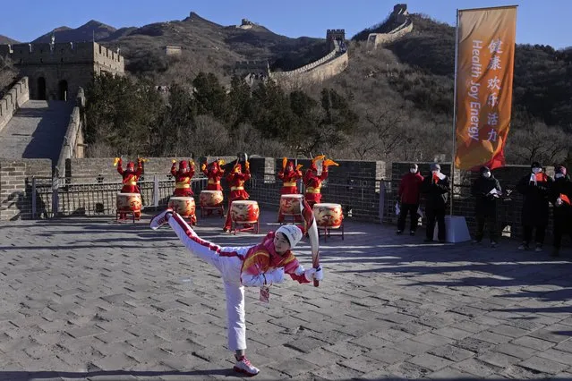 Wu Jingyu, China's Taekwondo Olympic Champion, poses with a kick before taking part in the torch relay for the 2022 Winter Olympics at the Badaling Great Wall on the outskirts of Beijing, China, Thursday, February 3, 2022. (Photo by Ng Han Guan/AP Photo)