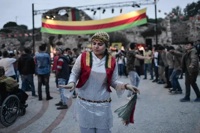 Kurdish community members living in Greece dance during Newroz celebrations on March 21, 2017 in Lavrio, some 80 kilometres from Athens. Kurds celebrate Newroz every year on the first day of spring, March 21, and is considered the most important festival in Kurdish culture. (Photo by Eleftherios Elis/AFP Photo)