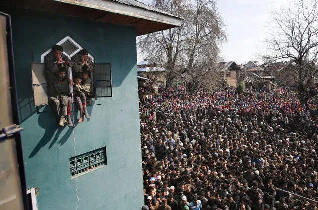 Kashmiri villagers attend the funeral of a local suspected rebel commander Tauseef Ahmed Wagay at Yaripora, about 60 Kilometres south of Srinagar, Indian controlled Kashmir, Wednesday, March 29, 2017. Thousands attended the funeral of Wagay in Indian controlled Kashmir Wednesday, a day after he was killed in a gunbattle with government forces in Kashmir. Three civilians were also killed and dozens injured in anti-India protests that erupted Tuesday following the gunbattle. (Photo by Mukhtar Khan/AP Photo)