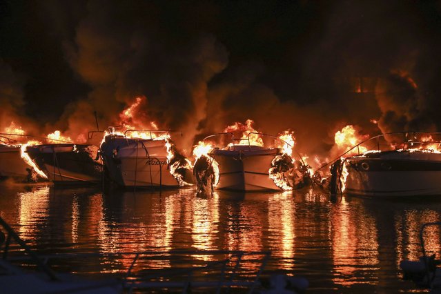 Boats are on fire in Medulin, Croatia, early Wednesday, May 15, 2024. A fire early on Wednesday at a marina in northwestern Croatia destroyed 22 boats and caused huge damage but no injuries. (Photo by Goran Sebelic/AP Photo)