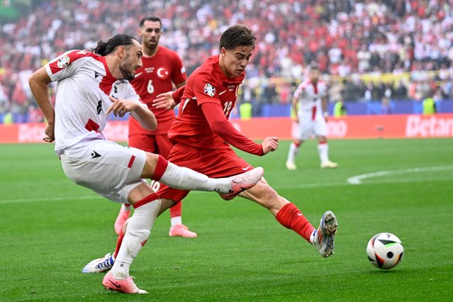 Georgia's midfielder #06 Giorgi Kochorashvili (L) fights for the ball with Turkey's forward #19 Kenan Yildiz during the UEFA Euro 2024 Group F football match between Turkey and Georgia at the BVB Stadion in Dortmund on June 18, 2024. (Photo by Ina Fassbender/AFP Photo)