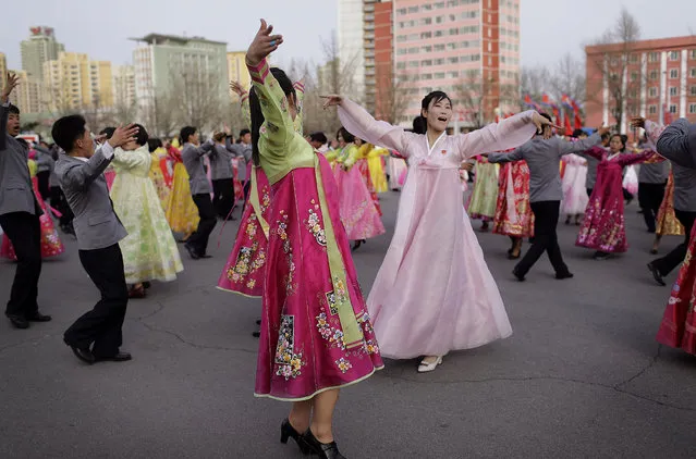 North Korean students participate in a mass dance event to mark the occasion of the late North Korean leader Kim Jong Il's election as chairman of the National Defense Committee in 1993, Sunday, April 9, 2017, in Pyongyang, North Korea. Mass dances are usually held to mark important dates and national holidays in the North Korean capital. (Photo by Wong Maye-E/AP Photo)