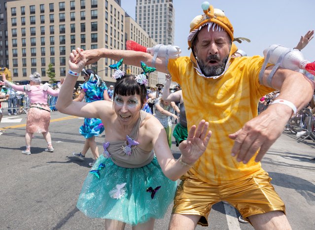People swing dance while participating in the Mermaid Parade in Coney Island, Brookly, New York City, U.S., June 22, 2024. (Photo by Caitlin Ochs/Reuters)