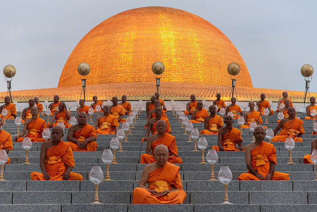 Buddhist monks meditate during the Vesak day celebration at Wat Phra Dhammakaya on May 22, 2024. Vesak Day or Vesakha Bucha Day is the day that commemorates the birth and enlightenment to Nirvana, and death of Buddha in the Buddhists faith. (Photo by Peerapon Boonyakiat/SOPA Image/Rex Features/Shutterstock)