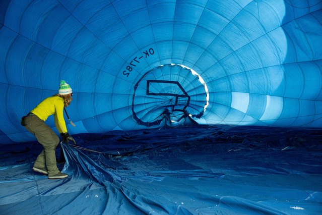 Pilot Amanda Brodbeck prepares her balloon during the 44th International Hot Air Balloon Festival in Chateau-d'Oex, Switzerland, on January 25, 2024. (Photo by Denis Balibouse/Reuters)