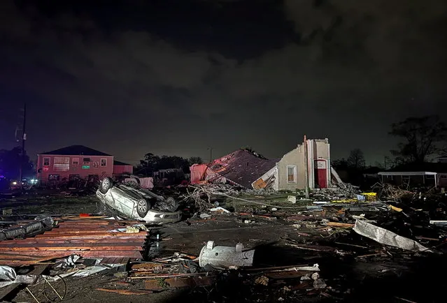 A car lies overturned among debris in the Arabi neighborhood after a large tornado struck New Orleans, Louisiana, U.S. March 22, 2022. (Photo by Kathleen Flynn/Reuters)