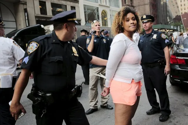 A protester is detained by New York Police Department officers during a march for Eric Garner's anniversary who was killed one year ago by police in New York July 17, 2015. (Photo by Eduardo Munoz/Reuters)