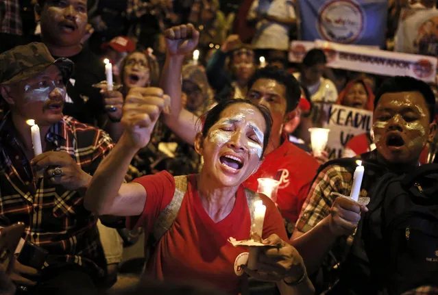 Supporters of Jakarta Governor Basuki “Ahok” Tjahaja Purnama light candles and shout slogans during a rally outside Cipinang Prison where he is being held after a court sentenced him to two years in prison, in Jakarta, Indonesia, Tuesday, May 9, 2017. Judges handed down the verdict for the minority Christian governor on Tuesday for blaspheming the Quran, a jarring ruling that undermines the reputation of the world's largest Muslim nation for practicing a moderate form of Islam. (Photo by Dita Alangkara/AP Photo)
