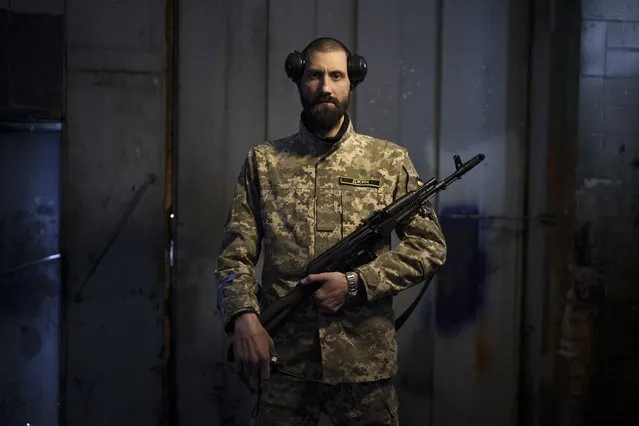 Sergiy Volosovets, 30, actor-turned-commander with the Territorial Defense Forces, poses for a photo in Brovary, on the outskirts of Kyiv, Ukraine, Wednesday, March 30, 2022. Volosovets now commands a unit of 11 men and oversees the military training of other volunteers at a base northeast of the capital, Kyiv. They are old, young, local, foreign, often new to war. Thousands of people have volunteered to join Ukraine’s Territorial Defense Forces and resist Russia’s invasion. The Associated Press this week spent time with some of them. (Photo by Felipe Dana/AP Photo)