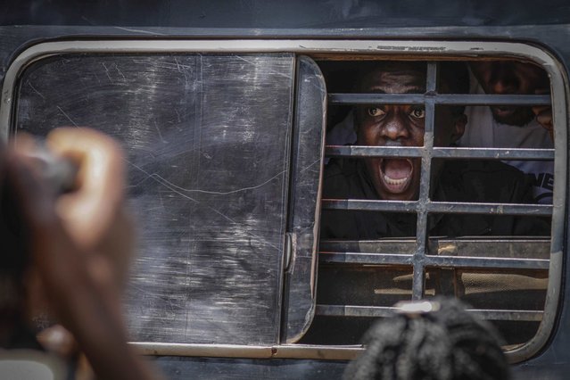 A protester screams as he is carried away with others after being arrested by military police during the anticorruption protest in Kampala, Uganda, Tuesday, July 23, 2024. Ugandan security forces on Tuesday arrested dozens of people who tried to walk to the parliament building to demonstrate against high-level corruption in protests that authorities say are unlawful. (Photo by Hajarah Nalwadda/AP Photo)