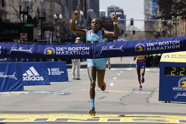 Peres Jepchirchir, of Kenya, crosses the finish line to win the women's division of the 126th Boston Marathon, Monday, April 18, 2022, in Boston. (Photo by Winslow Townson/AP Photo)