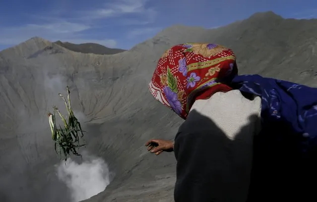 A Hindu worshipper throws vegetables into the crater as offerings during the Kasada Festival at Mount Bromo in Probolinggo, Indonesia's East Java province, August 1, 2015. (Photo by Reuters/Beawiharta)