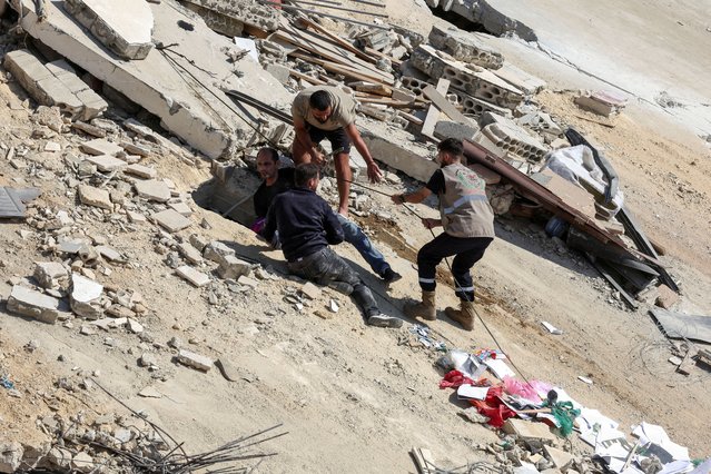 People carry out a rescue operation, at the site of Sunday's Israeli attack on the city of Ain Deleb, amid the ongoing hostilities between Hezbollah and Israeli forces, in southern Lebanon on September 30, 2024. (Photo by Aziz Taher/Reuters)