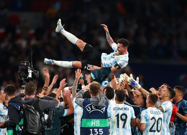 Lionel Messi of Argentina is thrown in the air by their teammates as they celebrate their sides victory in the 2022 Finalissima match between Italy and Argentina at Wembley Stadium on June 01, 2022 in London, England. (Photo by Alex Pantling/Getty Images)