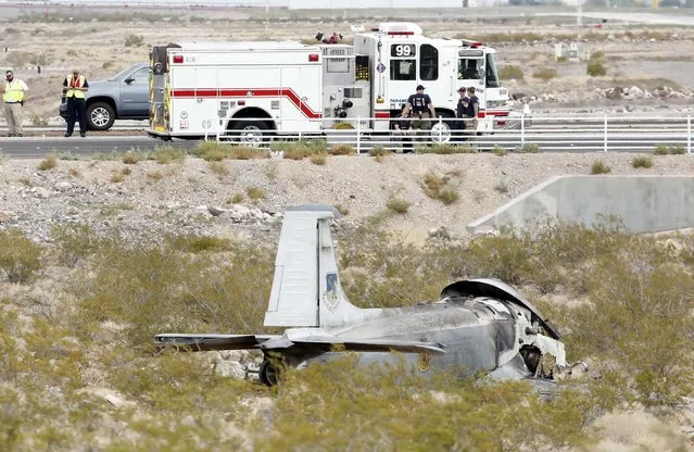 The wreckage of a vintage single-engine British-built military jet is shown after it crashed and burned in the desert just after takeoff from the Henderson Executive Airport in Henderson, Nev., Monday, July 24, 2017. The pilot escaped serious injury, authorities said. (Photo by Bizuayehu Tesfaye/Las Vegas Review-Journal via AP Photo)