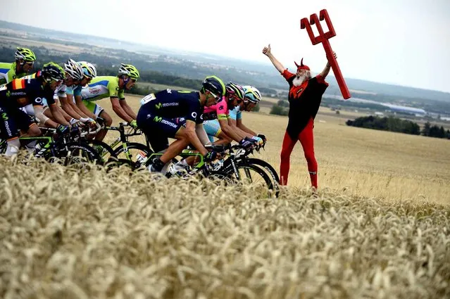 German fan Didi Senft known as El Diablo cheers as the pack rides past during the 234.5 km seventh stage of the 101st edition of the Tour de France cycling race on July 11, 2014 between Epernay and Nancy, northeastern France. (Photo by Lionel Bonaventure/AFP Photo)