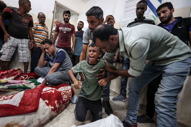 A child cries over the bodies of dead Palestinians at the Al-Awda Hospital in the Nuseirat refugee camp after an Israeli attack in Gaza City on Tuesday, September 24, 2024. (Photo by Ali Jadallah/Anadolu/Getty Images)