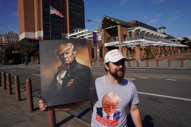 Joe Livaudais, from Virginia, holds an image depicting Donald Trump on Election Day in Philadelphia, Pennsylvania on November 5, 2024. (Photo by Seth Herald/Reuters)