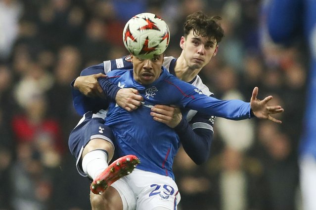 Tottenham's Archie Gray, rear, challenges Rangers' Hamza Igamane during the Europa League opening phase soccer match between Glasgow Rangers and Tottenham Hotspur at Ibrox stadium in Glasgow, Thursday, December 12, 2024. (Photo by Scott Heppell/AP Photo)