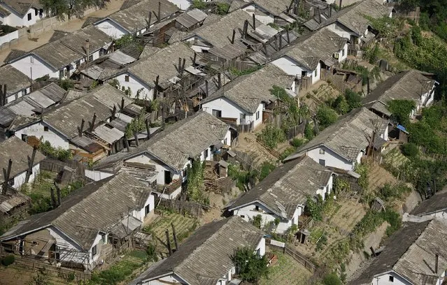 Residential houses and farmlands are seen on the banks of Yalu River in North Korean city of Manpo, Chagang province, August 16, 2014. (Photo by Jacky Chen/Reuters)