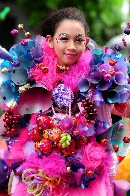 A model wears a chemistry inspired costume in the kids carnival during the 13th Jember Fashion Carnival 2014 on August 21, 2014 in Jember, Indonesia. (Photo by Robertus Pudyanto/Getty Images)