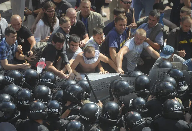 Ukrainian protesters clash with police after a vote to give greater powers to the east in front of the Parliament, Kiev, Ukraine, Monday, August 31, 2015. (Photo by Andrew Kravchenko/AP Photo)