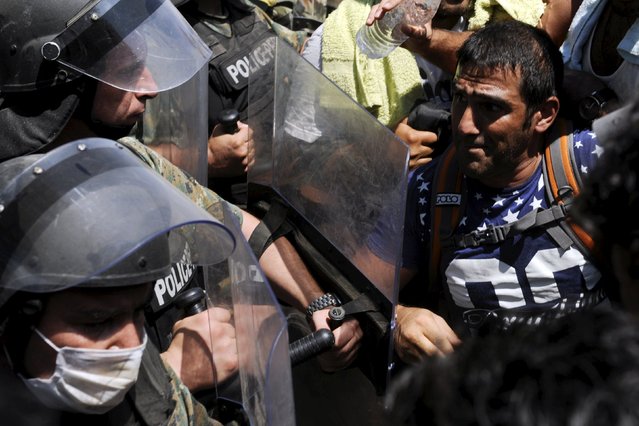 Macedonian special police forces try to bring order as they regulate the flow of migrants crossing the Greek border into Macedonia, near the village of Idomeni, September 2, 2015. (Photo by Alexandros Avramidis/Reuters)