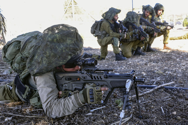 Israeli soldiers keep a position while troops train in the upper Galilee region of northern Israel near the border with Lebanon on November 8, 2023, amid increasing cross-border tensions between Hezbollah and Israel as fighting continues in the south with Hamas militants in the Gaza Strip. (Photo by Jalaa Marey/AFP Photo)