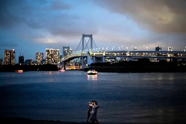 People take pictures at Odaiba Marine Park in Tokyo on September 4, 2022. (Photo by Philip Fong/AFP Photo)