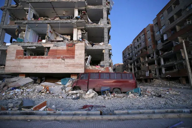 In this photo provided by the Iranian Students News Agency, ISNA, destroyed buildings and a car are seen after an earthquake at the city of Sarpol-e-Zahab in western Iran, Monday, November 13, 2017. (Photo by Pouria Pakizeh/ISNA via AP Photo)