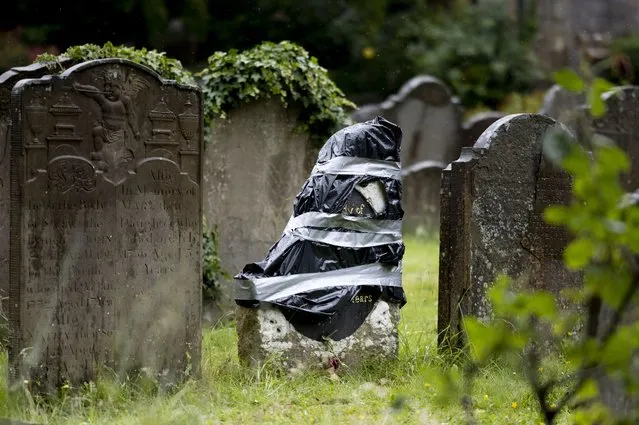 The damaged headstone of Scipio Africanus at St Mary's Churchyard on June 18, 2020 in Bristol, England. The headstone of African man Scipio Africanus who was enslaved in the 18th Century has been smashed in two at St Mary's Churchyard. A local councillor believes it was a retaliatory act following the toppling of a statue honouring Edward Colston, an English merchant and slave trader from Bristol. (Photo by Matthew Horwood/Getty Images)