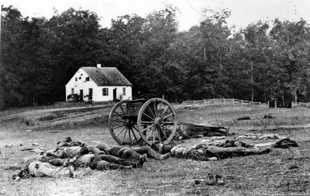 Bodies of fallen troops and a crashed gun lie on the field after the Battle of Antietam, the bloodiest one-day battle of the American Civil War, near Sharpsburg, Md., on September 17, 1862. The Dunker Church, a German Baptist Brethren, is riddled with artillery in the background.  The Battle of Antietam, led by Confederate Army Gen. Robert E. Lee, was the first major battle on Northern soil.  (Photo by Mathew B. Brady/AP Photo)